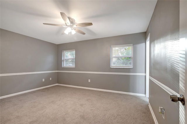 carpeted empty room featuring ceiling fan and a healthy amount of sunlight