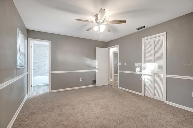 unfurnished bedroom with carpet, a closet, and ceiling fan