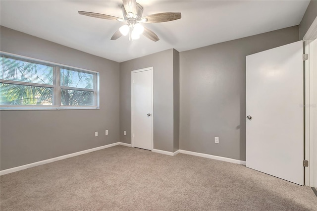 unfurnished bedroom featuring ceiling fan and light carpet