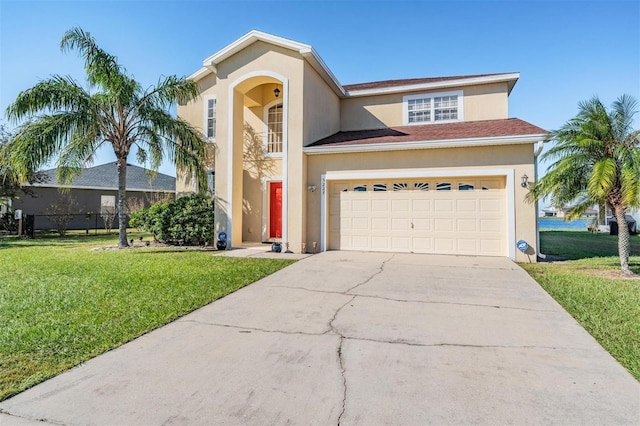 view of front facade with a garage and a front lawn