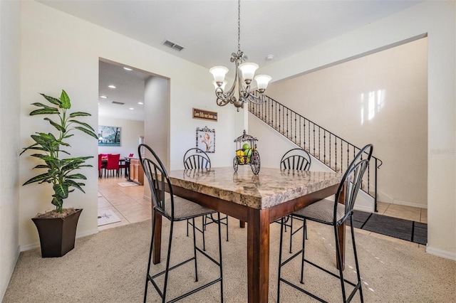 dining space with an inviting chandelier and light colored carpet