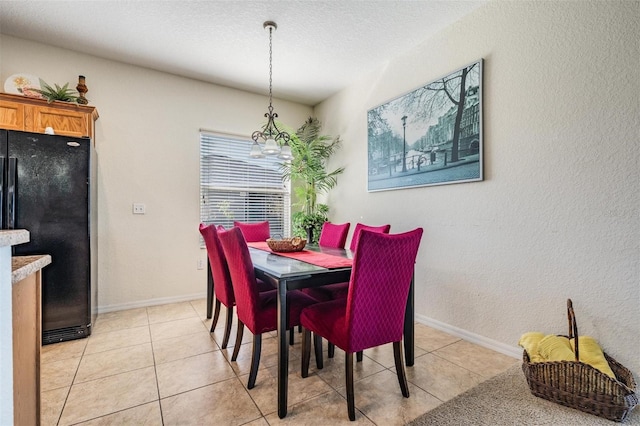 tiled dining area with a chandelier