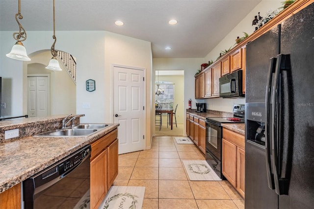 kitchen with light tile patterned flooring, black appliances, sink, and pendant lighting