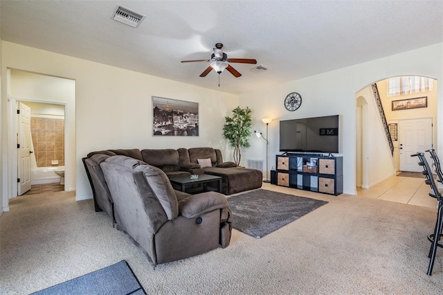 living room featuring light colored carpet and ceiling fan