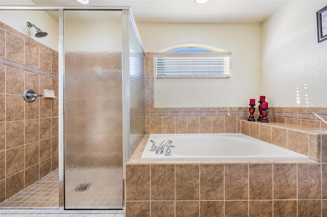 bathroom featuring independent shower and bath