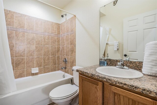 full bathroom featuring vanity, shower / bath combination with curtain, and toilet