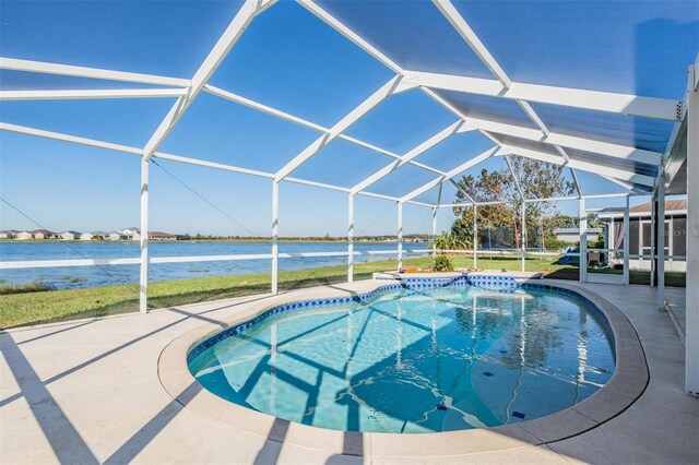 view of pool with a water view, a patio area, and a lanai