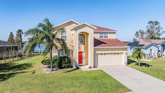 mediterranean / spanish home featuring a front yard and a garage