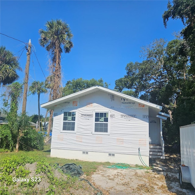 5831 Michigan Ave, New Port Richey, FL 34652 - view of side of home featuring crawl space and entry steps