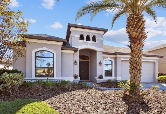 mediterranean / spanish home featuring a garage