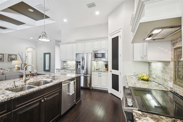 kitchen featuring decorative backsplash, white cabinetry, dark wood-type flooring, and appliances with stainless steel finishes