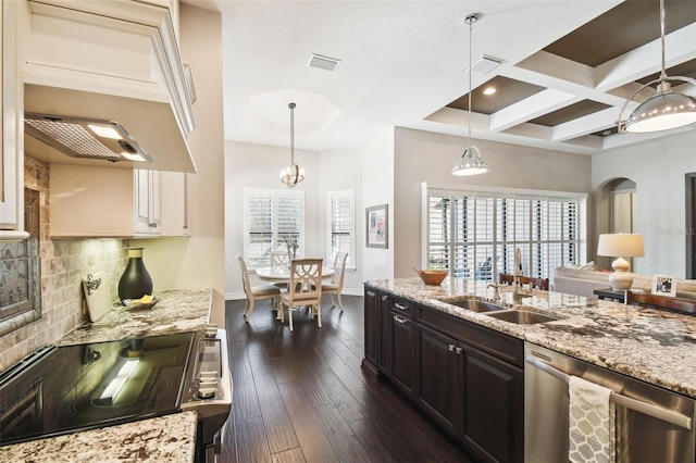 kitchen featuring dishwasher, dark wood-type flooring, coffered ceiling, tasteful backsplash, and custom exhaust hood