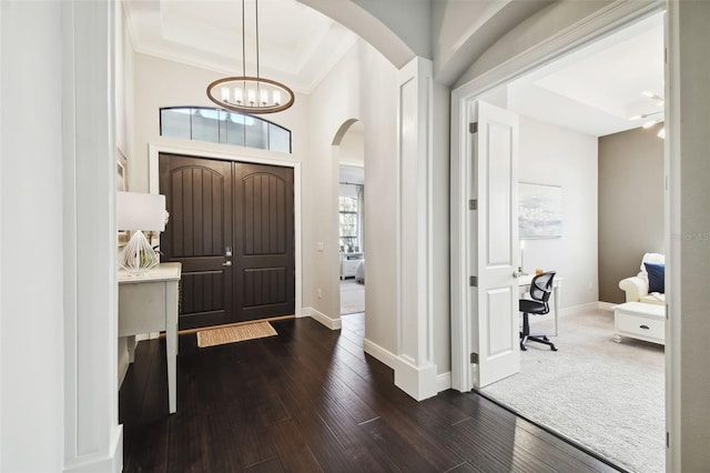 entrance foyer featuring a chandelier, dark hardwood / wood-style flooring, and crown molding