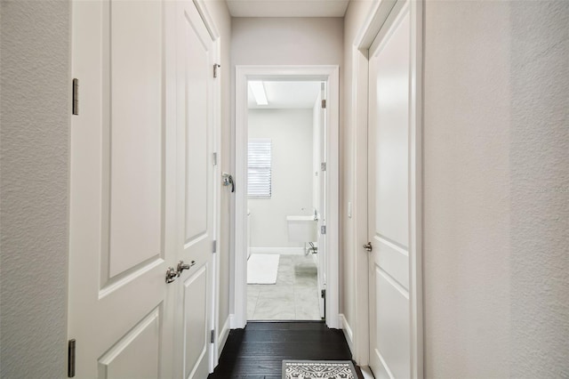 hallway with dark hardwood / wood-style flooring