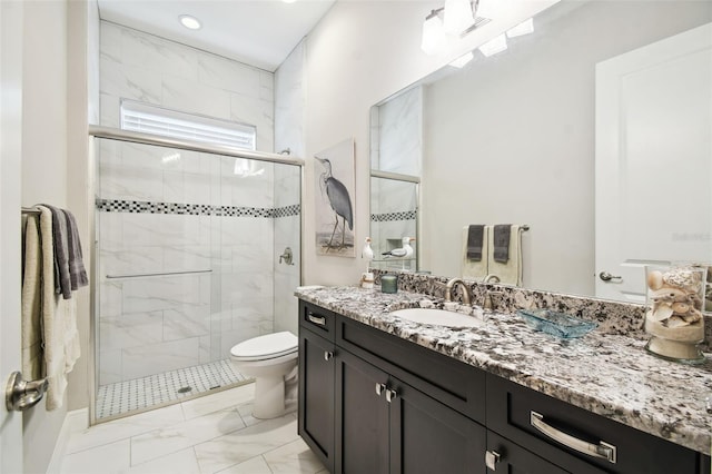 bathroom with vanity, toilet, and an enclosed shower