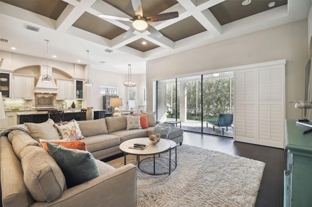 living room with beamed ceiling, dark wood-type flooring, and coffered ceiling