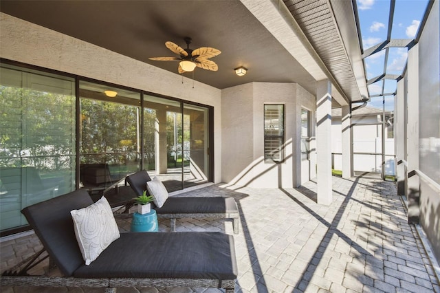 view of patio with ceiling fan and a lanai