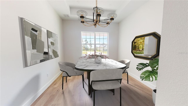 dining space with an inviting chandelier and light wood-type flooring