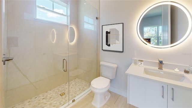 bathroom with walk in shower, vanity, toilet, and plenty of natural light