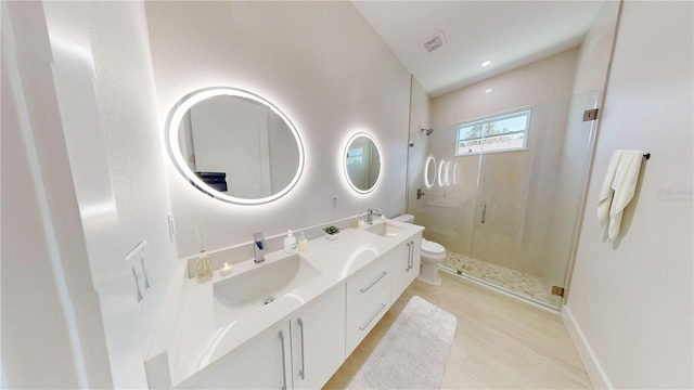 bathroom with vanity, a shower with shower door, toilet, and tile patterned flooring