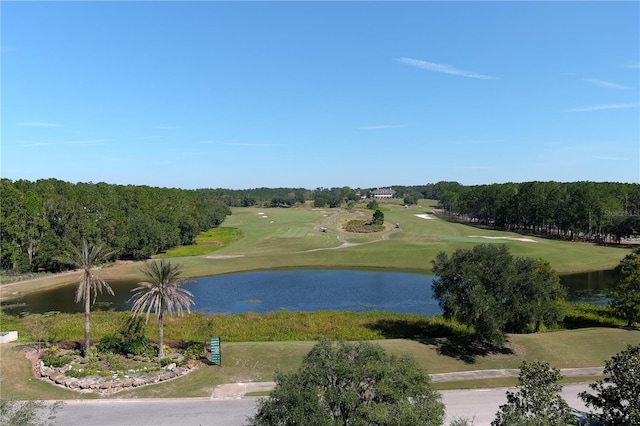 surrounding community with a yard and a water view