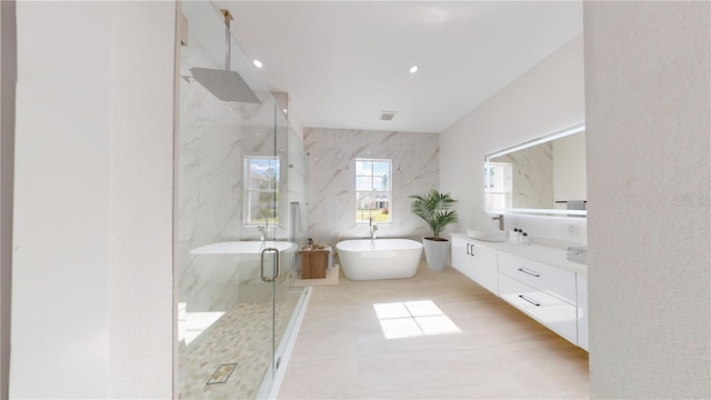 bathroom featuring vanity, independent shower and bath, and tile patterned flooring