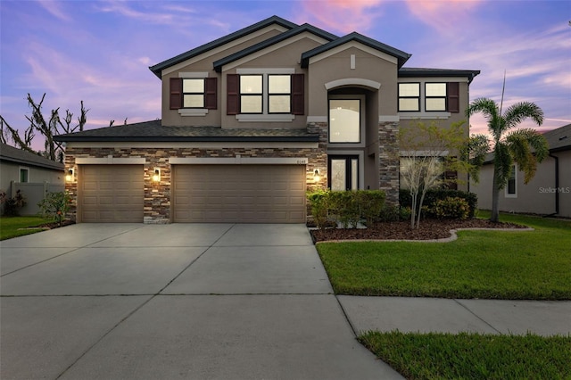 view of front of house featuring a yard and a garage