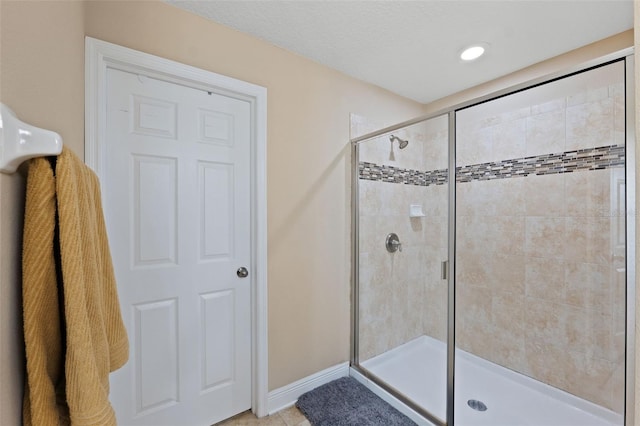 bathroom with tile patterned flooring and an enclosed shower