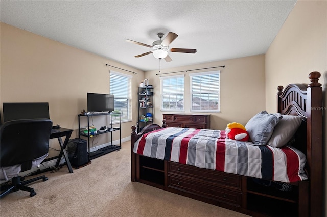 bedroom featuring light carpet, a textured ceiling, and ceiling fan