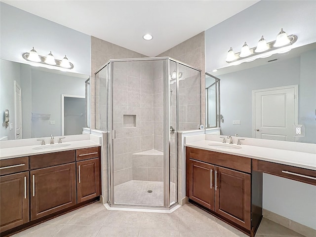 bathroom with tile patterned flooring, vanity, and a shower with shower door