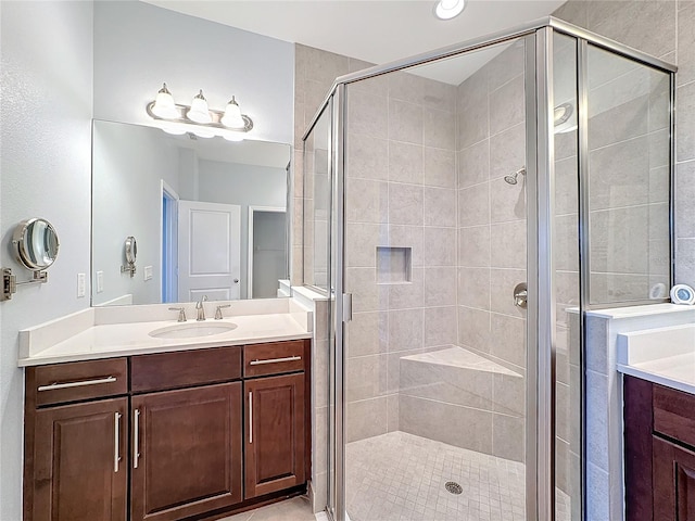 bathroom featuring vanity and a shower with door