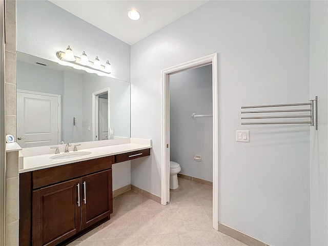 bathroom featuring tile patterned flooring, vanity, and toilet