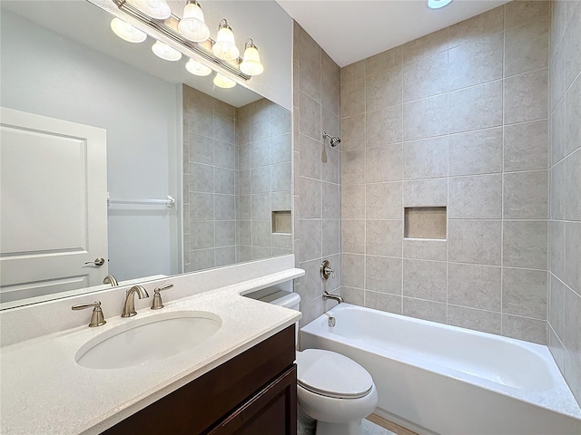 full bathroom with vanity, toilet, and tiled shower / bath