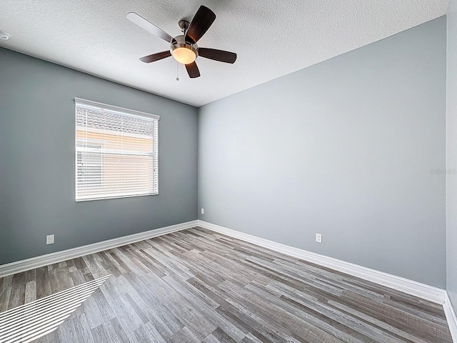 spare room with hardwood / wood-style floors, a textured ceiling, and ceiling fan