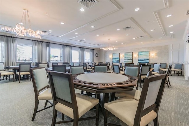 carpeted dining room featuring a notable chandelier