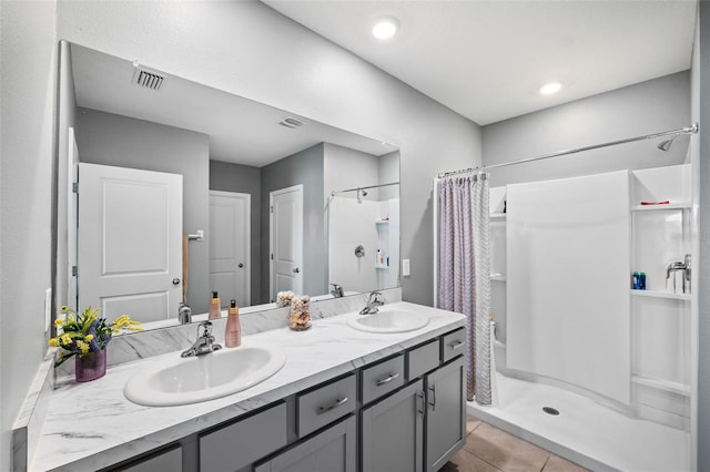 bathroom with a shower with curtain, vanity, and tile patterned flooring