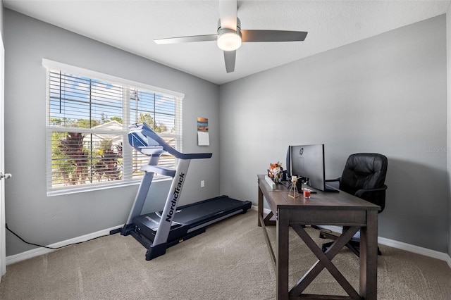 home office featuring ceiling fan, plenty of natural light, and carpet flooring