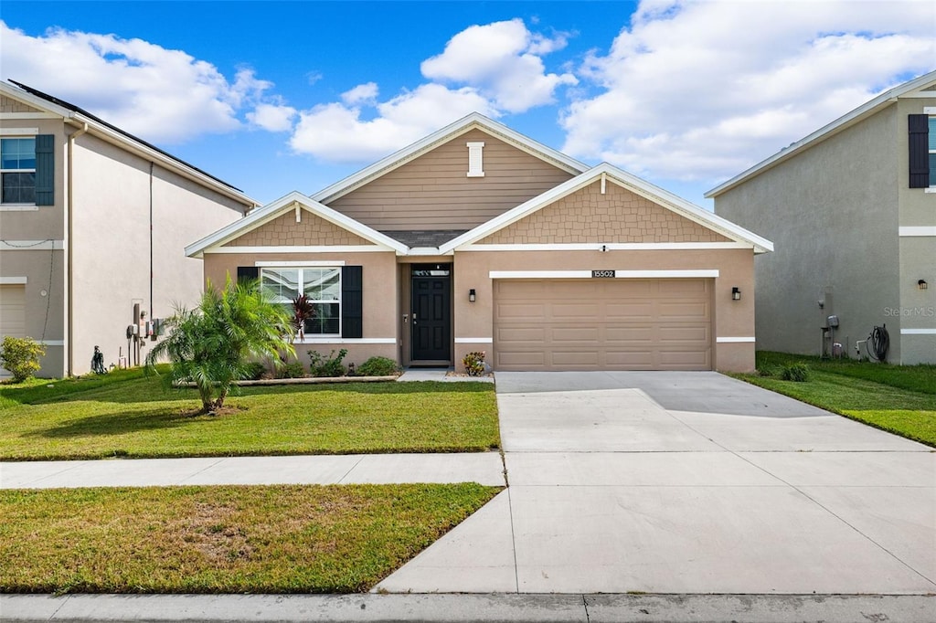 view of front of property featuring a garage and a front yard