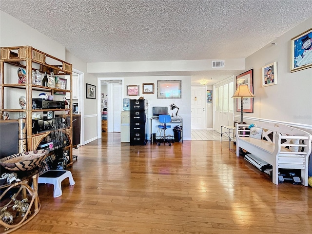 interior space with hardwood / wood-style flooring and a textured ceiling