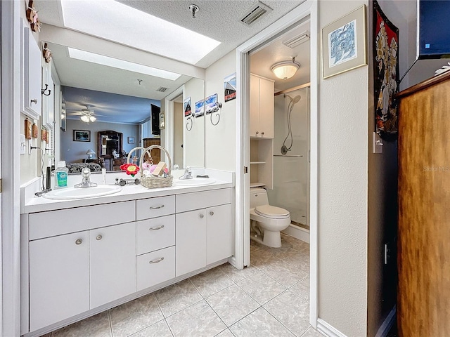 bathroom with vanity, toilet, a shower with door, and tile patterned flooring