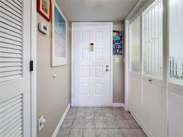 entryway featuring a textured ceiling and light tile patterned floors