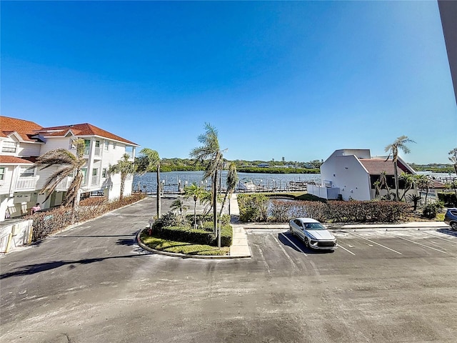 view of vehicle parking featuring a water view