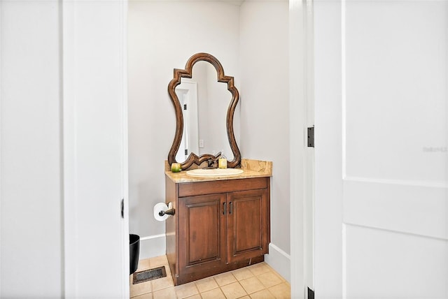 bathroom featuring visible vents, vanity, baseboards, and tile patterned floors