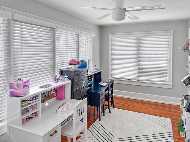 office area with ceiling fan, wood finished floors, and baseboards