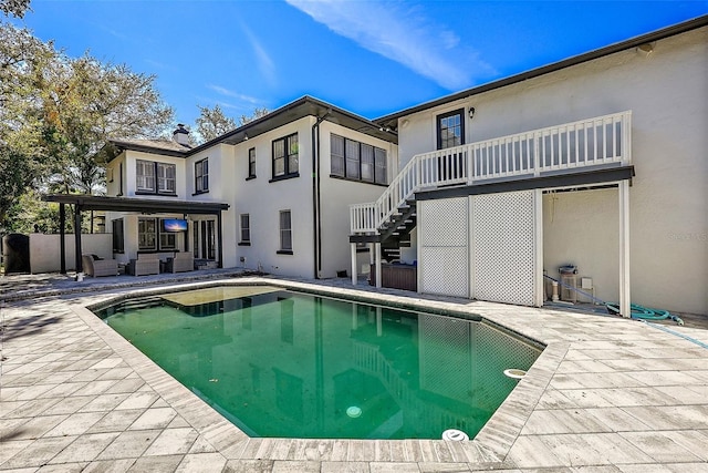 outdoor pool featuring a patio area and stairs