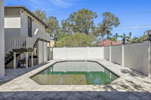 view of swimming pool with a patio area, a fenced backyard, stairs, and a fenced in pool