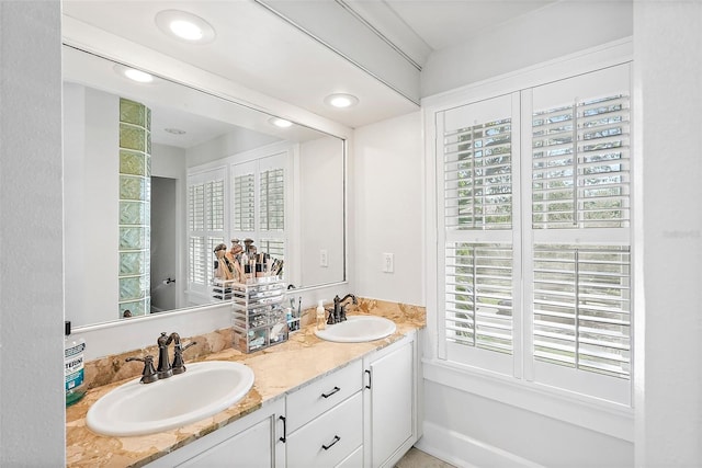 bathroom with recessed lighting, a sink, and double vanity