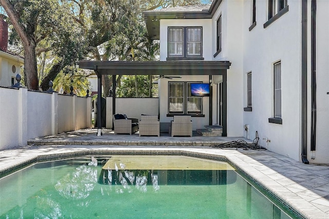 view of swimming pool featuring a fenced in pool, a fenced backyard, a patio, and ceiling fan