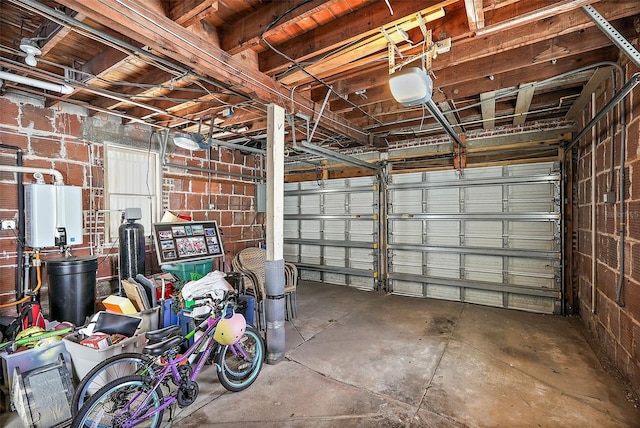 garage featuring tankless water heater and a garage door opener