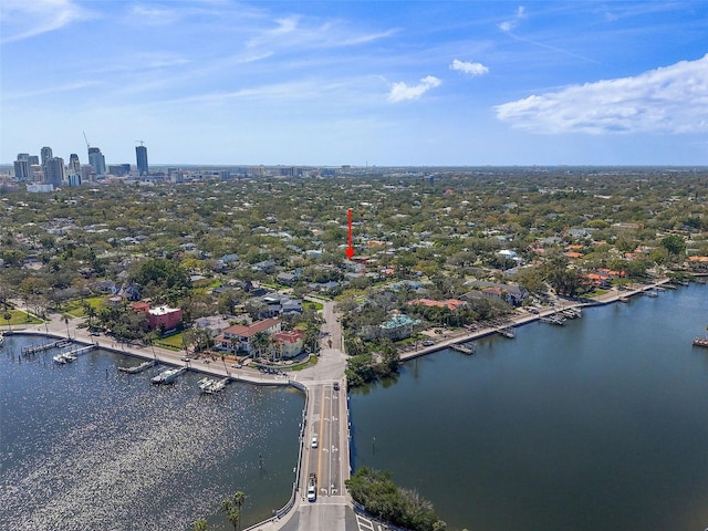 birds eye view of property with a view of city and a water view